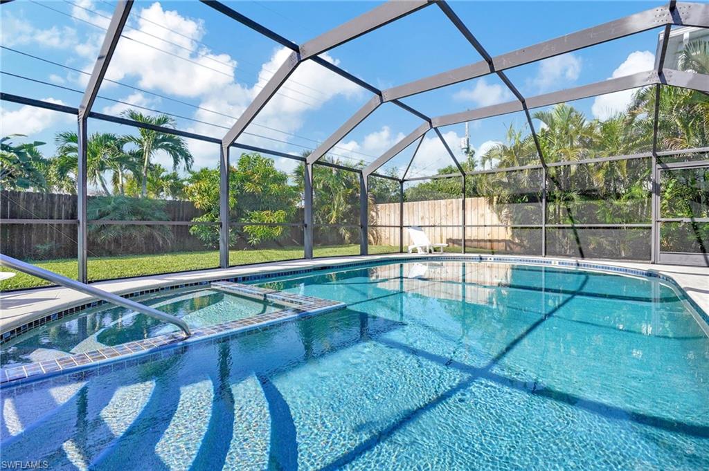 View of pool with an in ground hot tub and a lanai