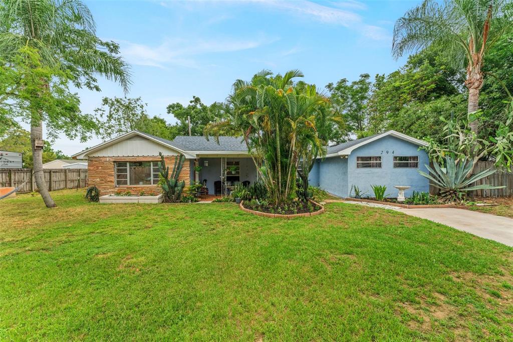 a front view of a house with yard and green space