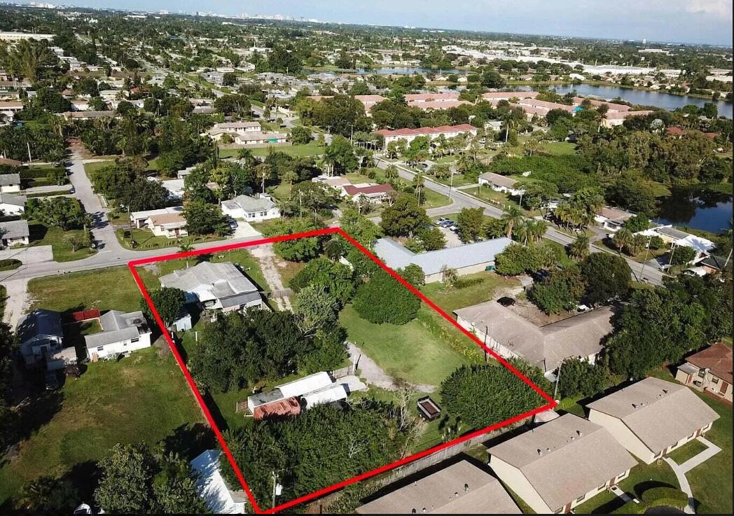 an aerial view of residential houses with outdoor space and street view