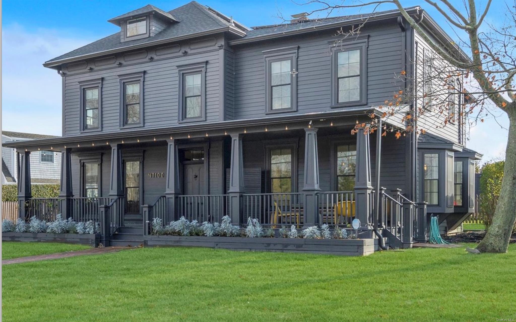 a front view of house with yard and outdoor seating