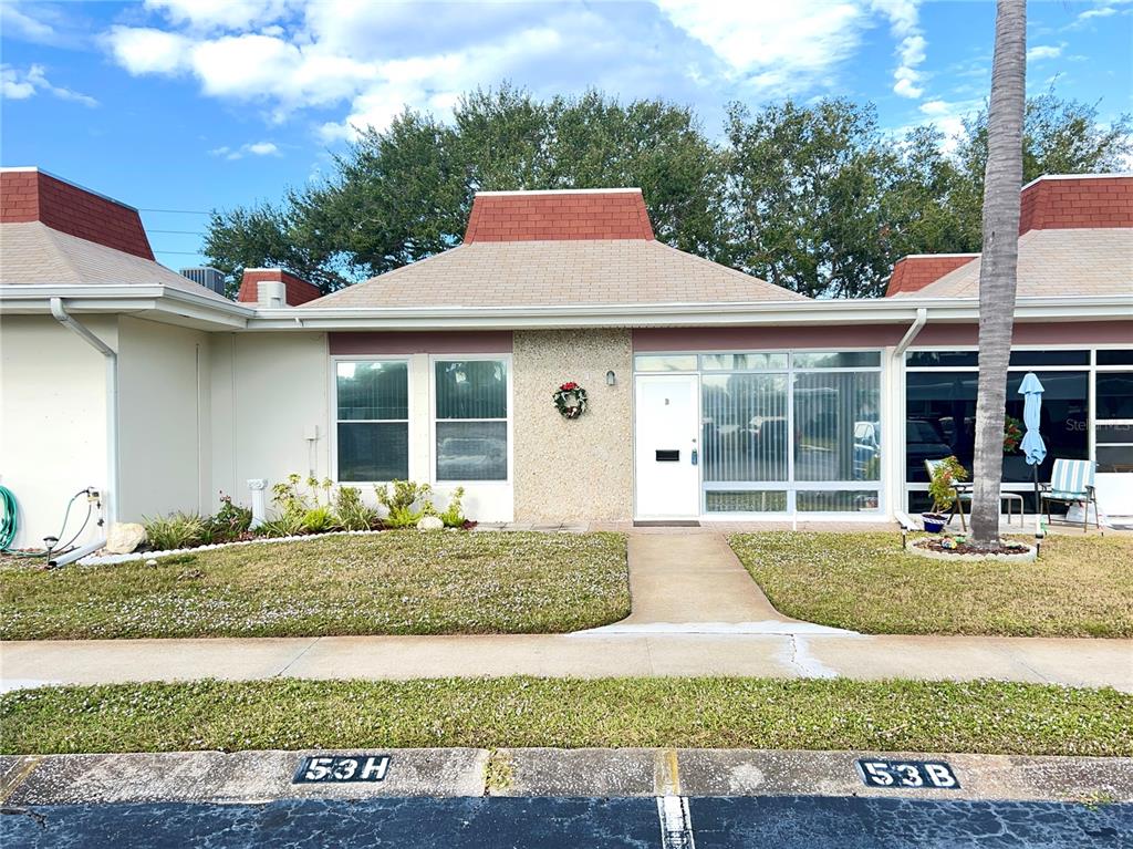 a front view of a house with garden