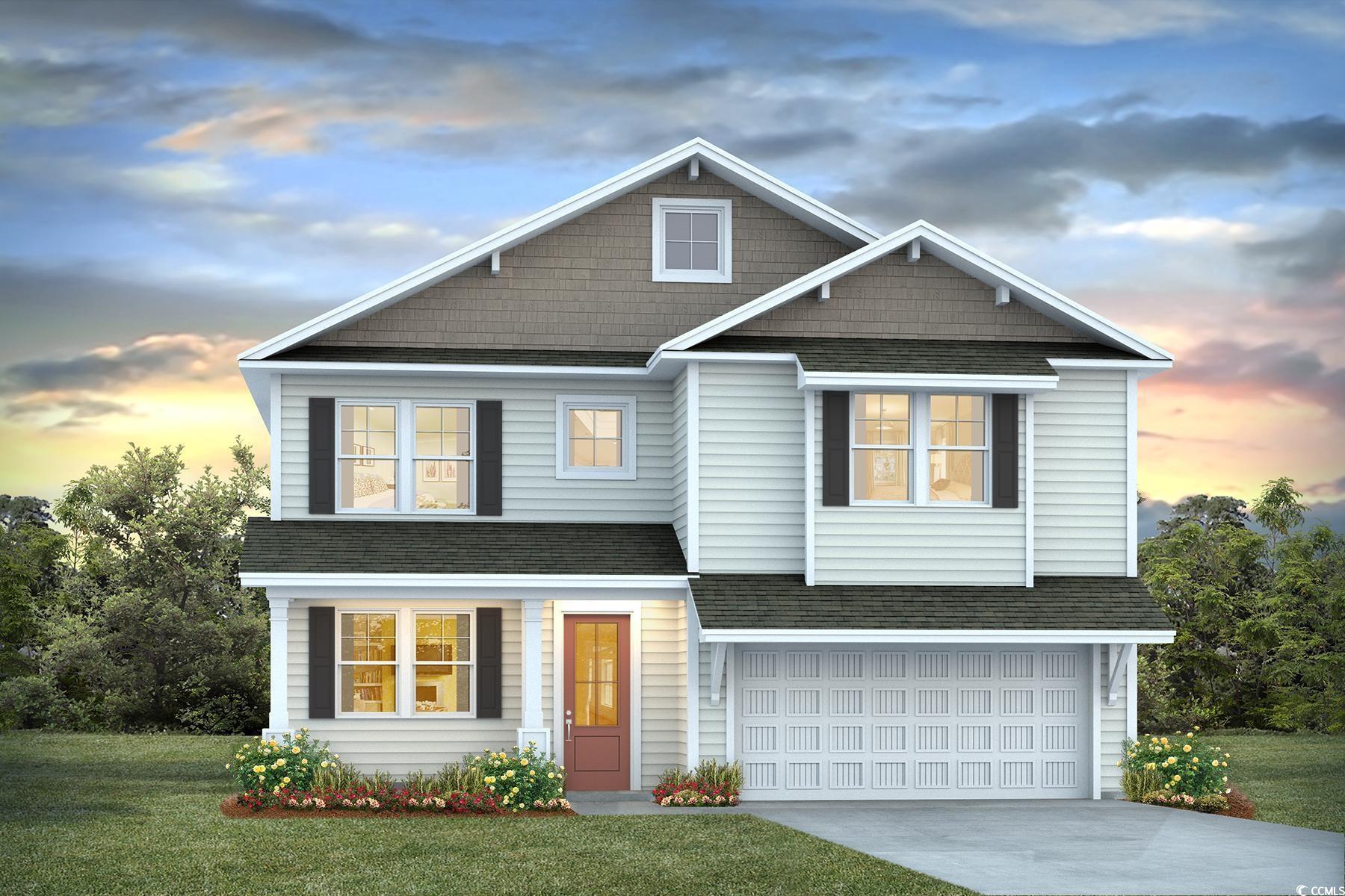 View of front of home with a yard and a garage