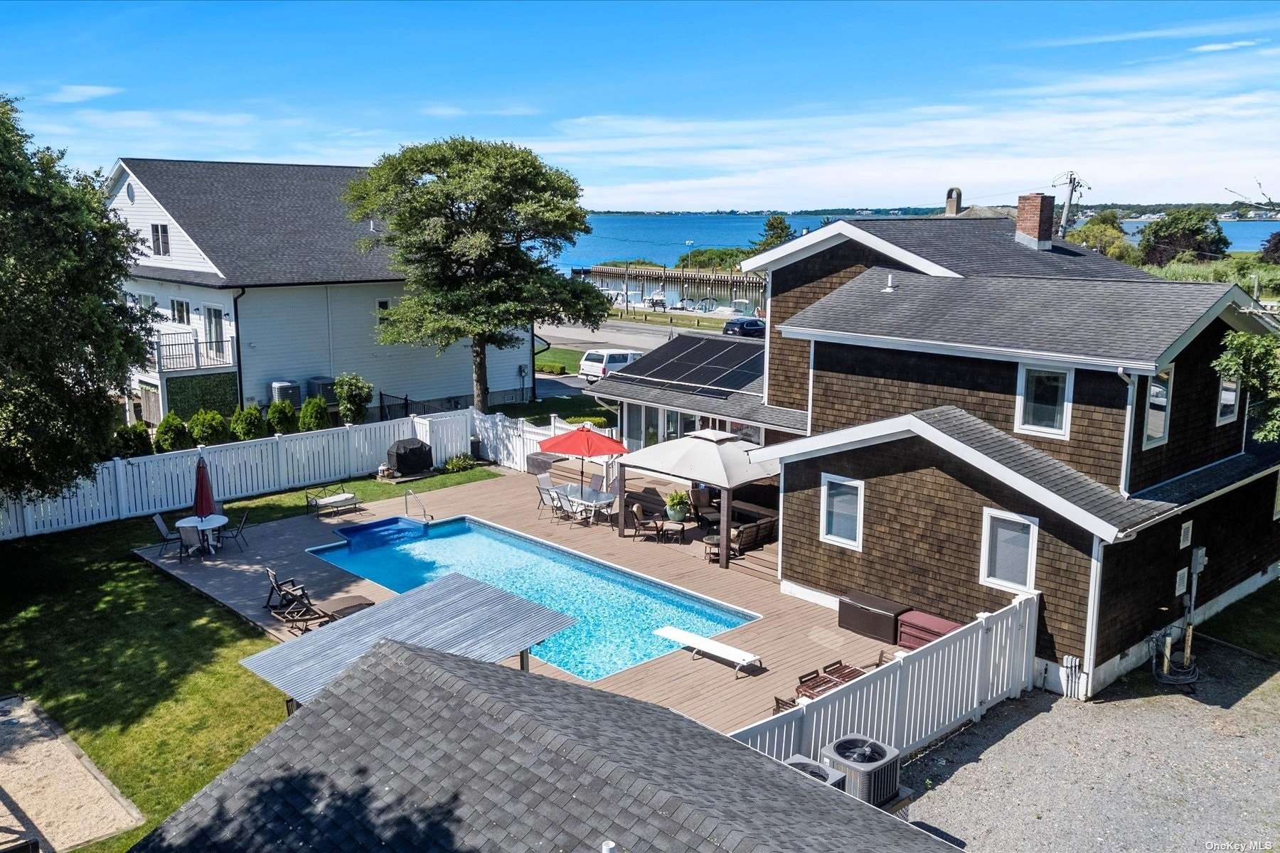 a view of a house with pool and chairs