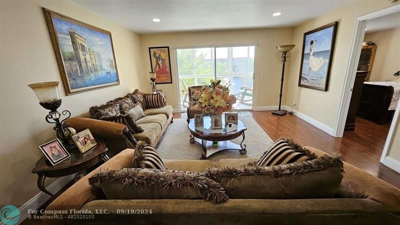 a living room with furniture window and a flat screen tv