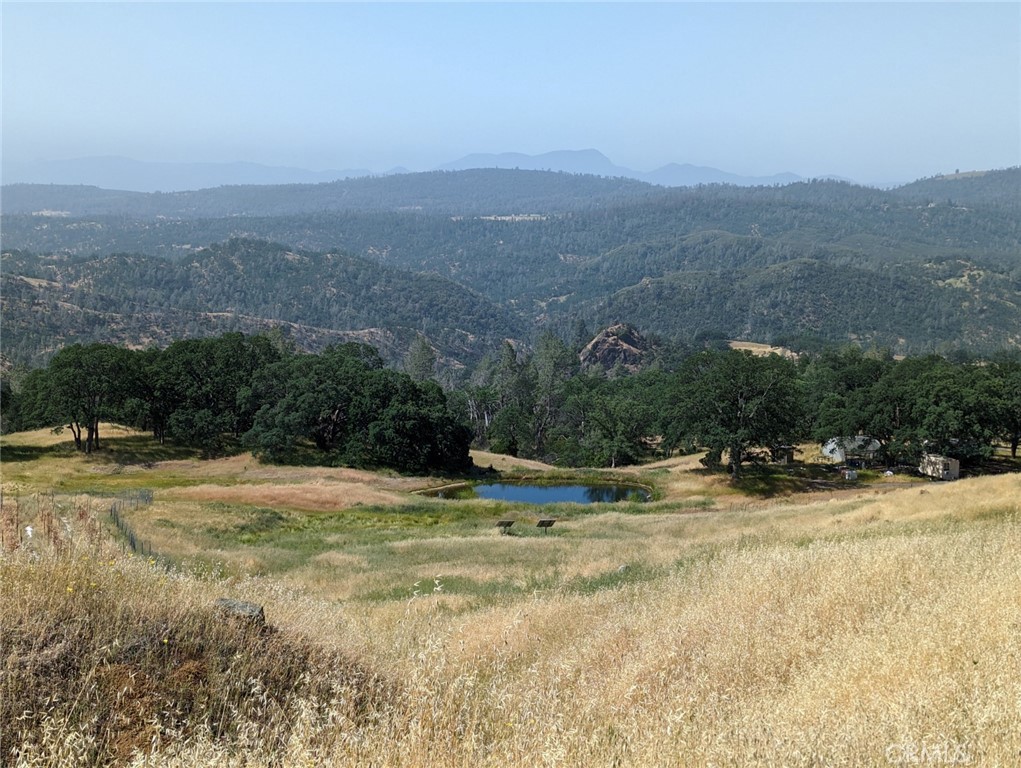 a view of a field with mountains in the background