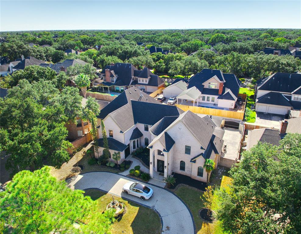 an aerial view of a house with a swimming pool outdoor seating and yard