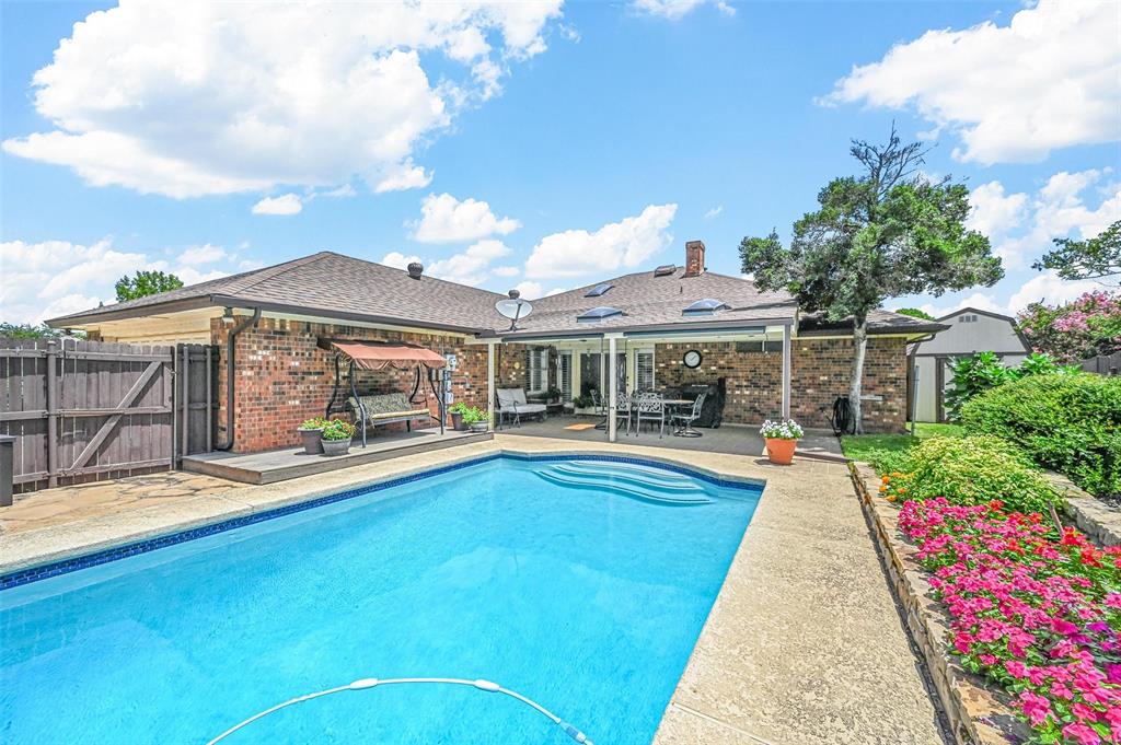 a view of a house with swimming pool and sitting area