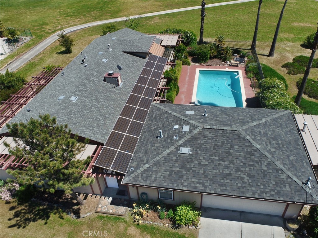 a aerial view of a house with a garden and lake view