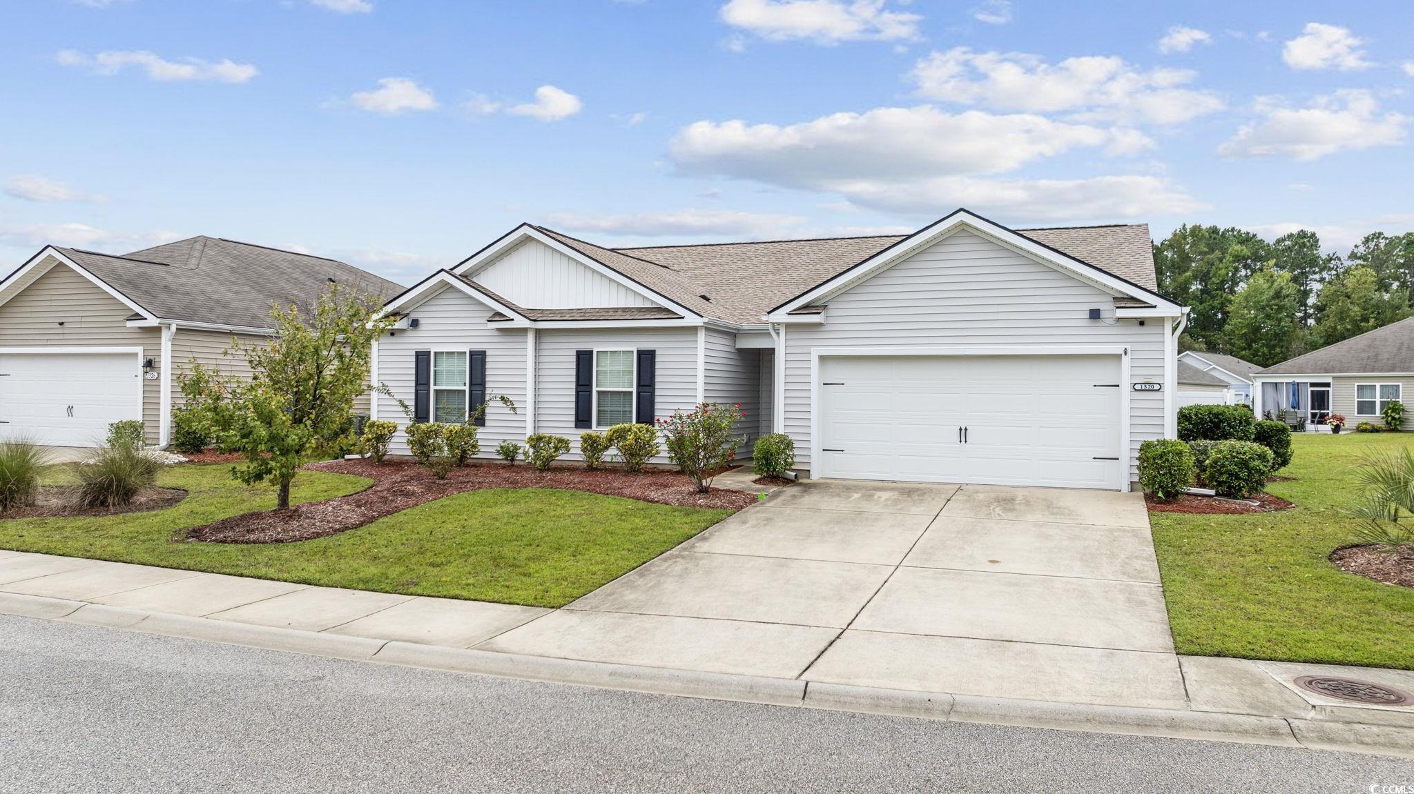 Ranch-style house with a front lawn and a garage