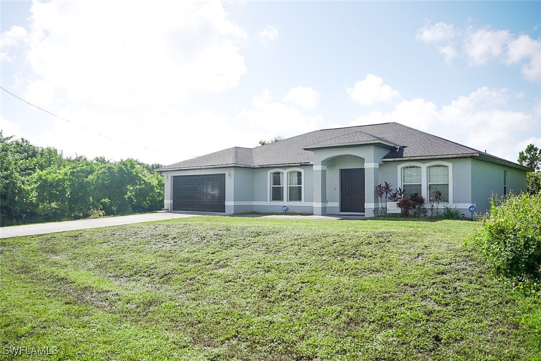 a front view of a house with a garden