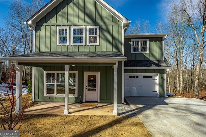 View of front of home featuring a garage and covered porch