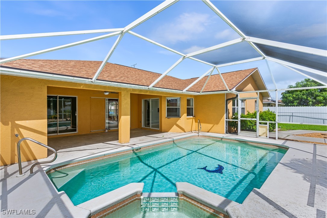 a view of a house with backyard and sitting area