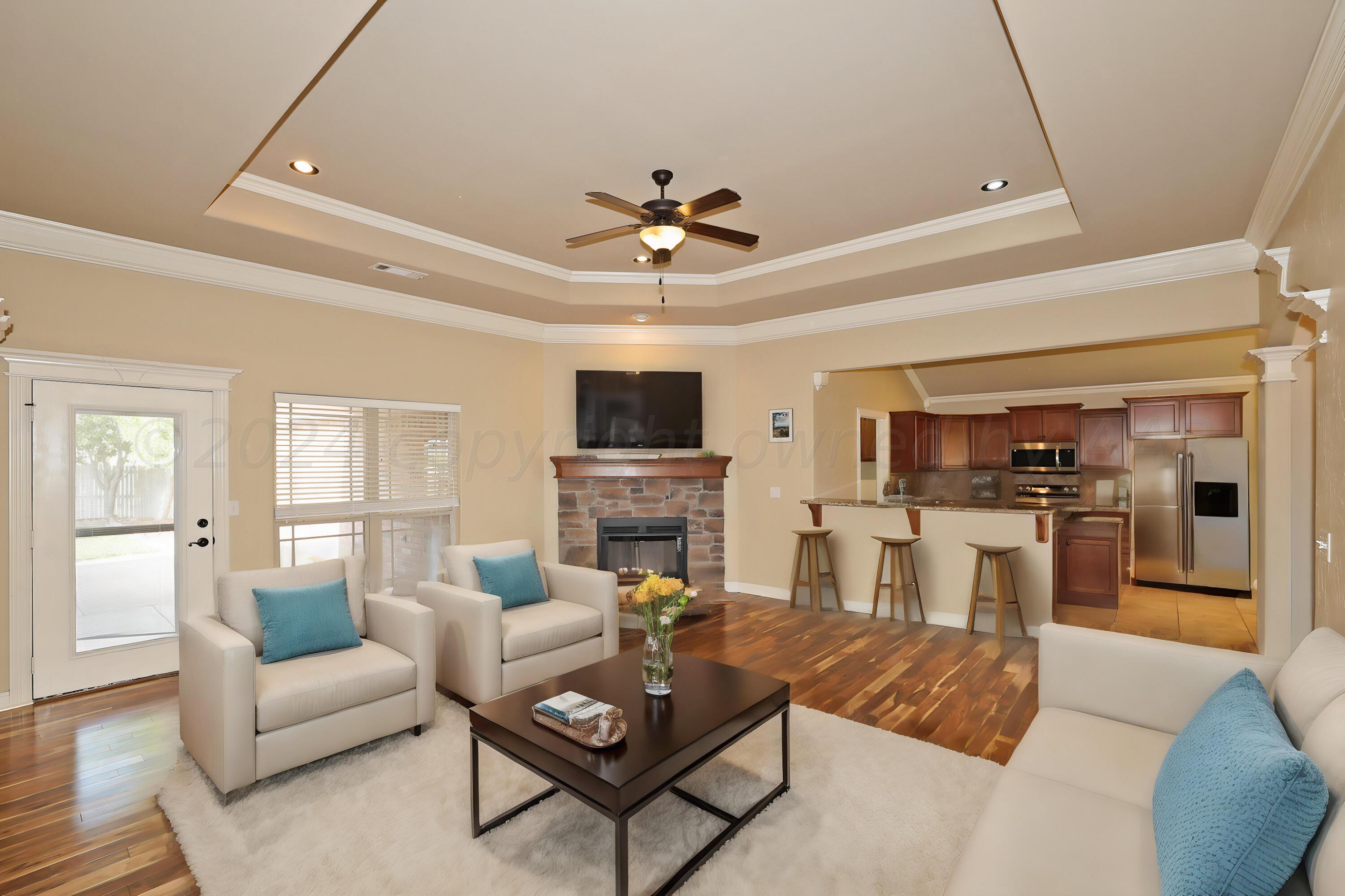 a living room with fireplace furniture and a flat screen tv