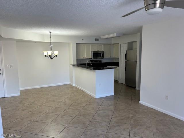 a kitchen with granite countertop a sink a counter top space and appliances