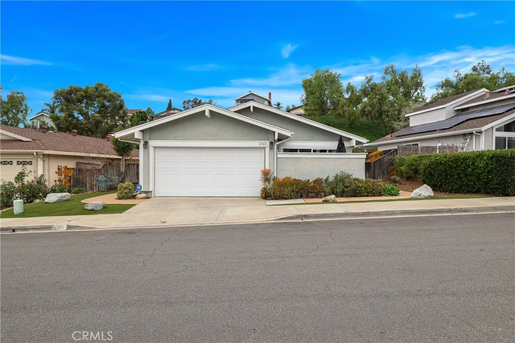 a view of a house with a yard and garage