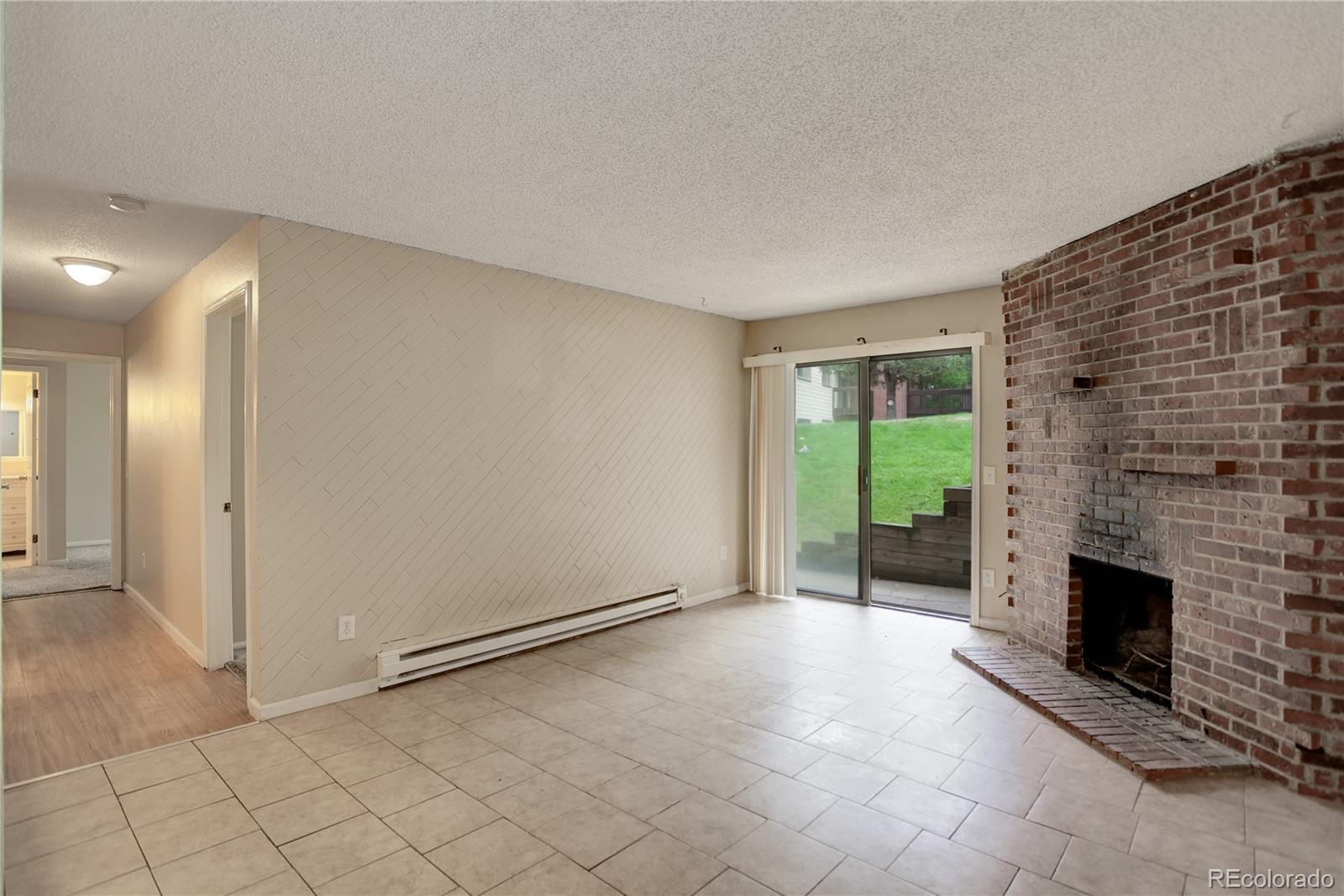 a view of an empty room with a fireplace