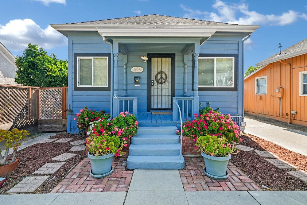 a front view of a house with flower pots