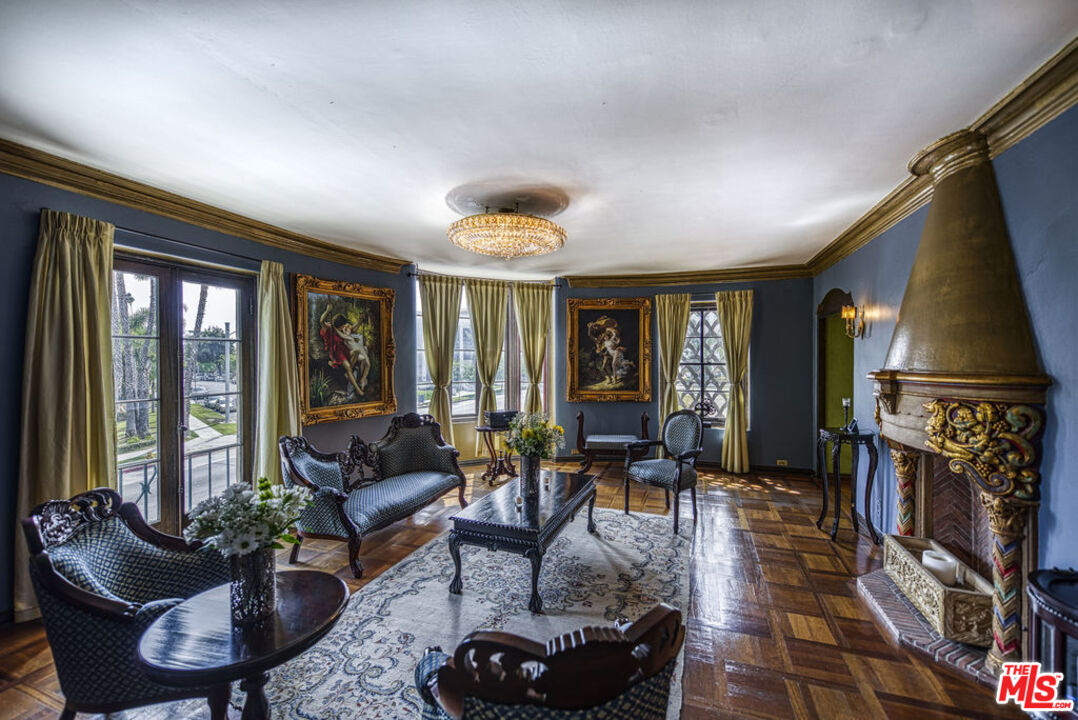 a living room with furniture a flat screen tv and a large window