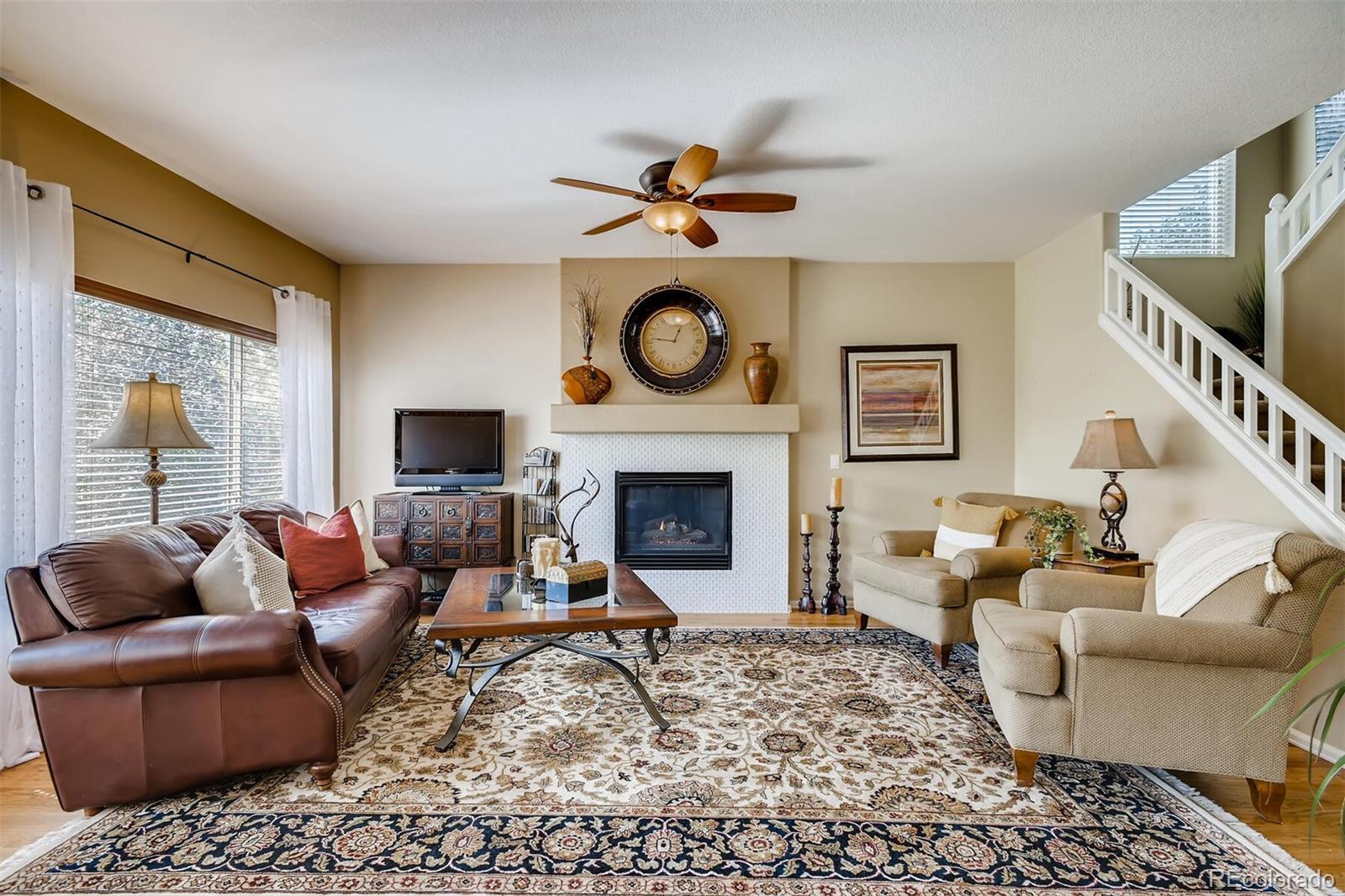 a living room with furniture a rug and a fireplace