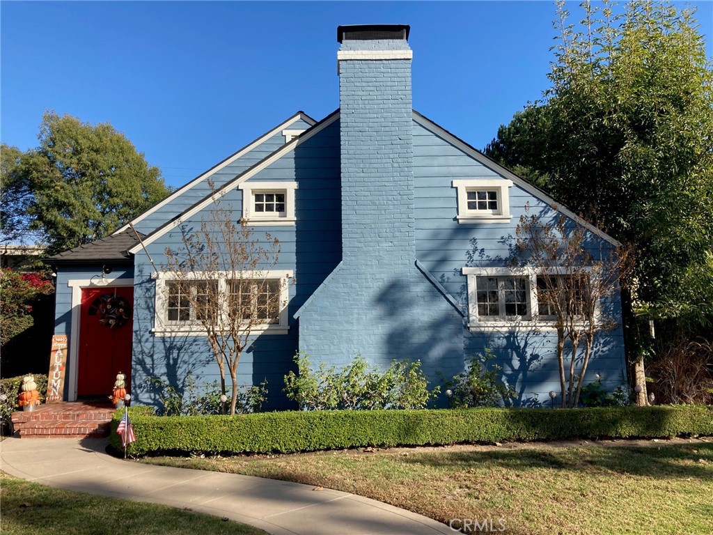 a front view of a house with a garden