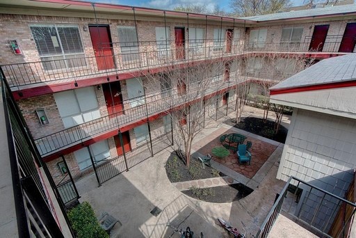 a balcony with furniture and wooden floor