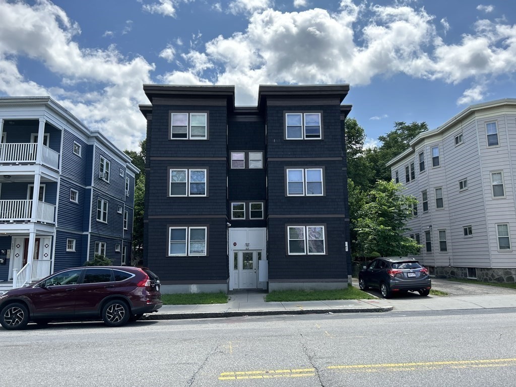 a car parked in front of a brick house