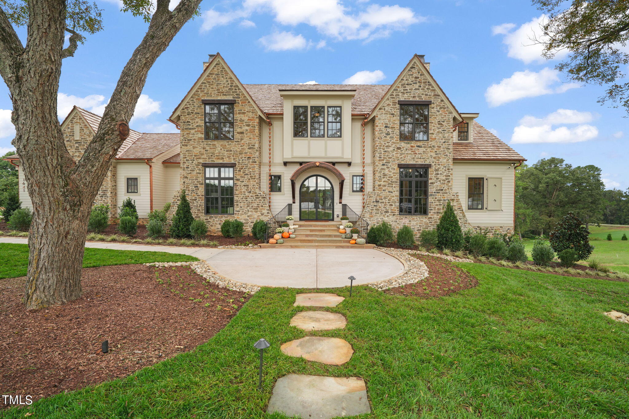 a front view of a house with a garden