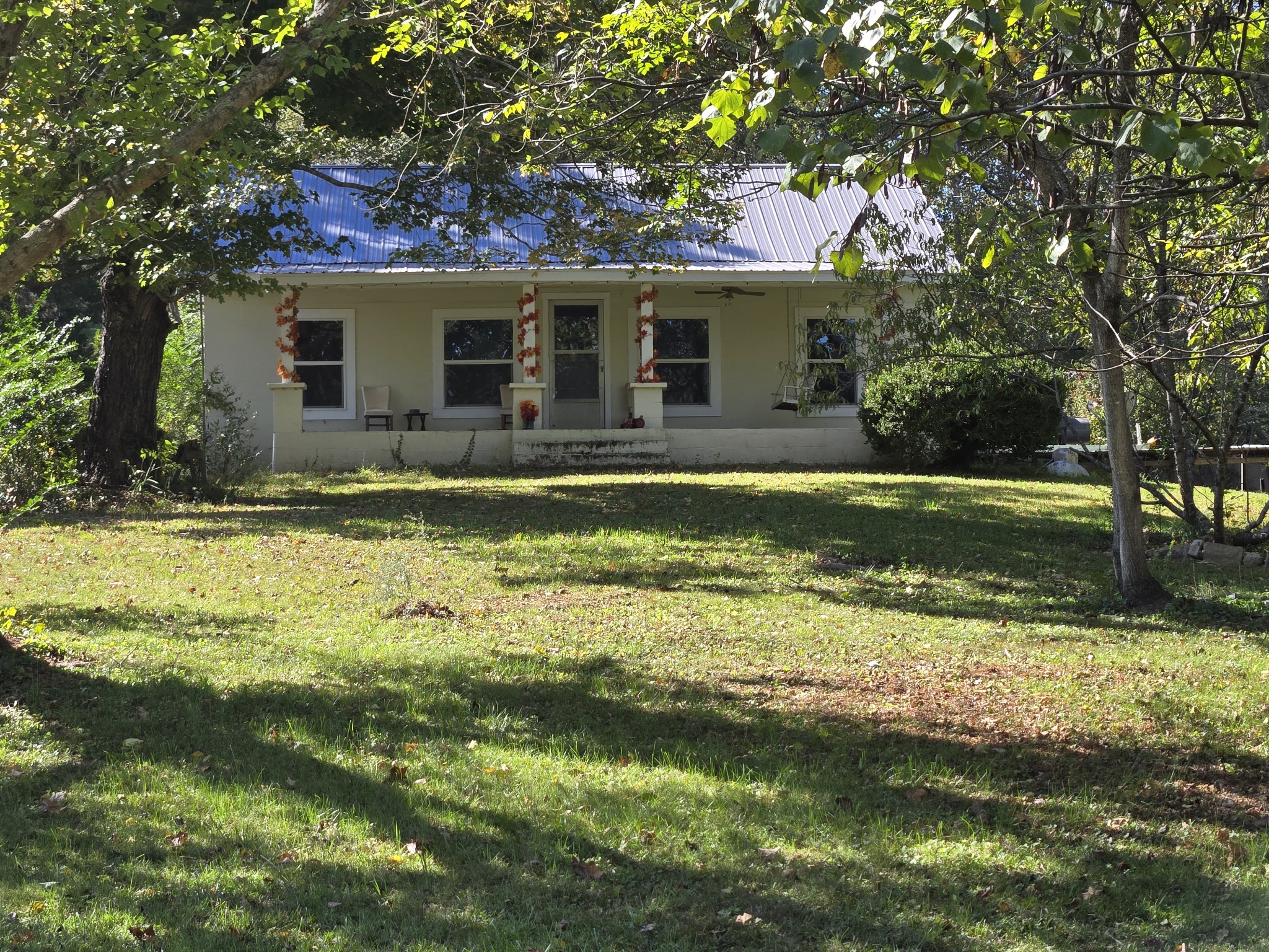 a view of a house with a yard patio and swimming pool