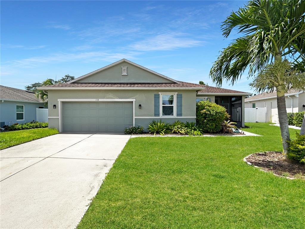 a front view of a house with a yard and garage