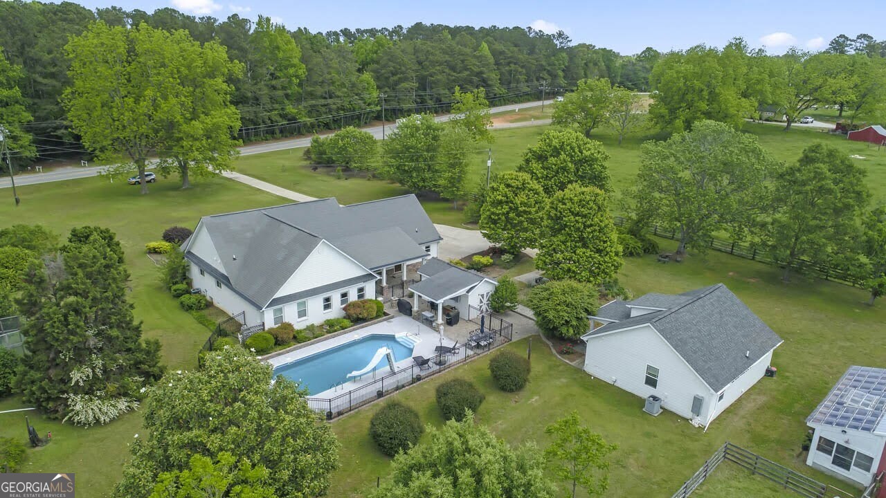 an aerial view of a house with pool