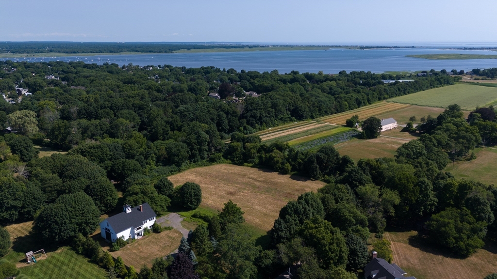 an aerial view of residential house with outdoor space and trees all around