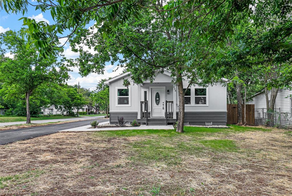 a house that has a tree in front of the house