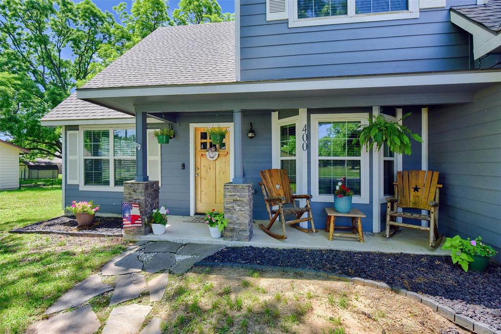 a view of a house with backyard porch and sitting area