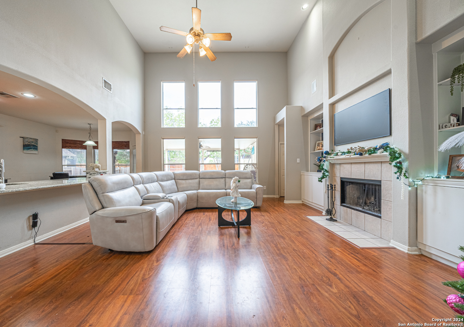 a living room with furniture a fireplace and a large window