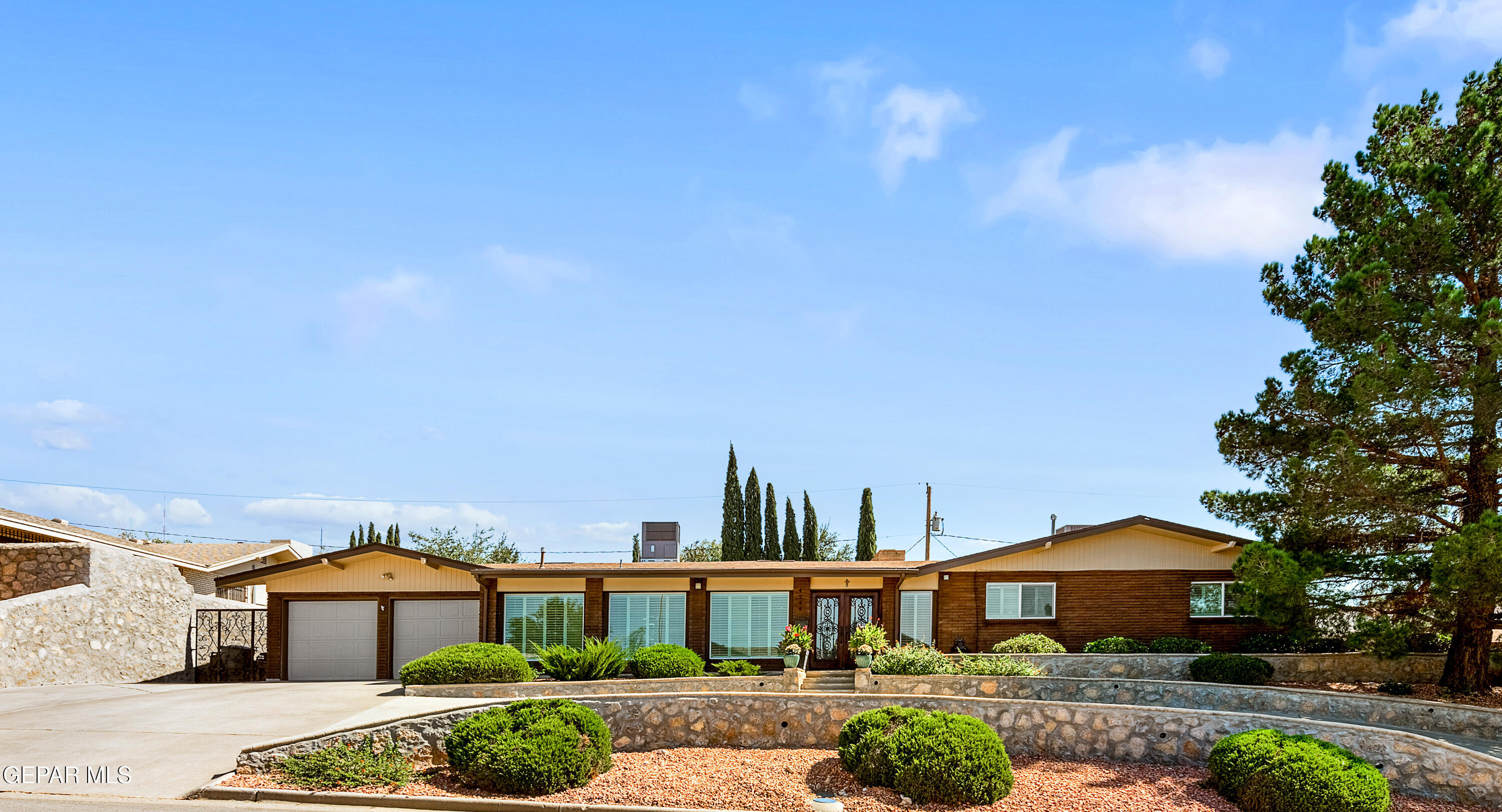 a front view of a house with garden