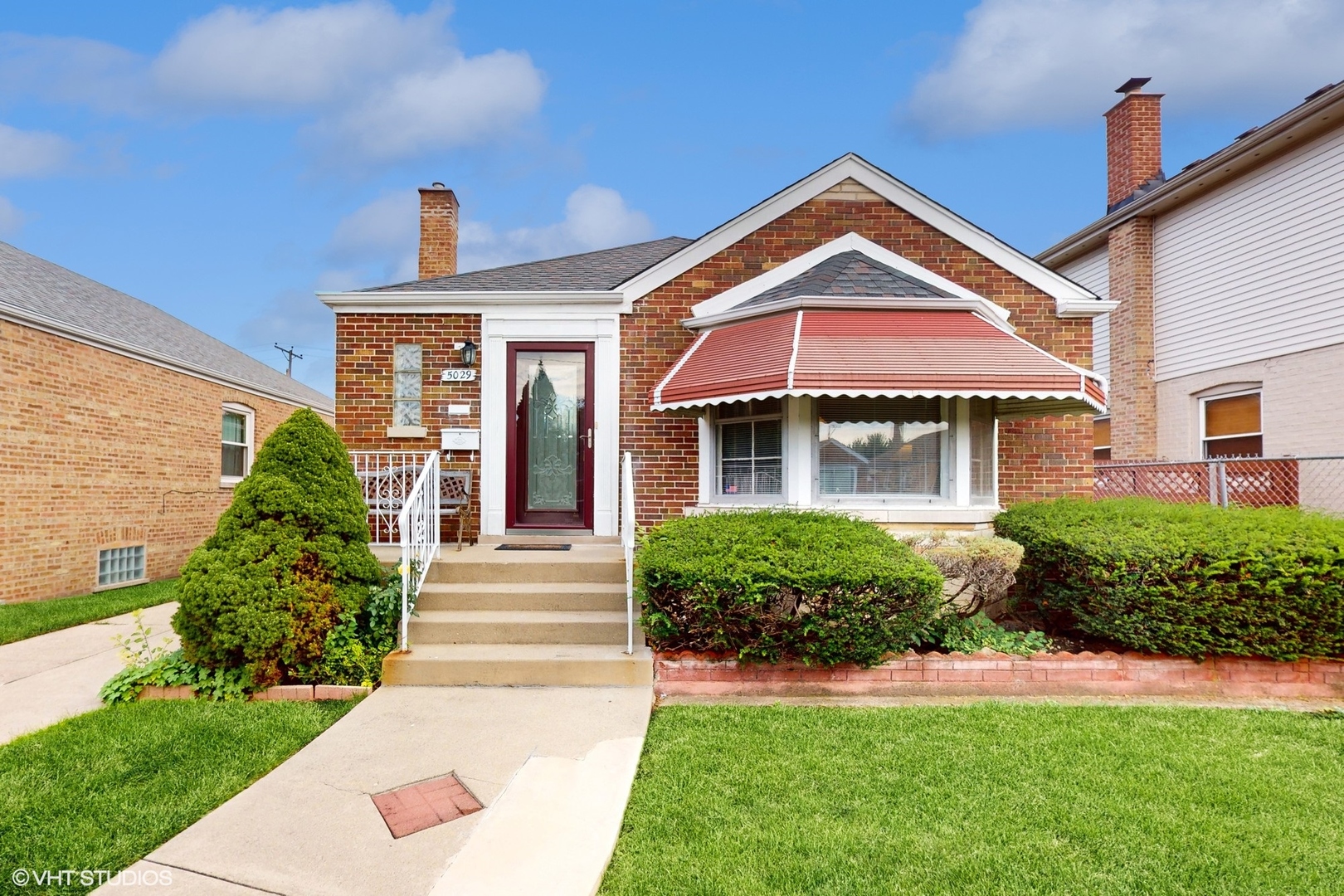 a front view of a house with garden