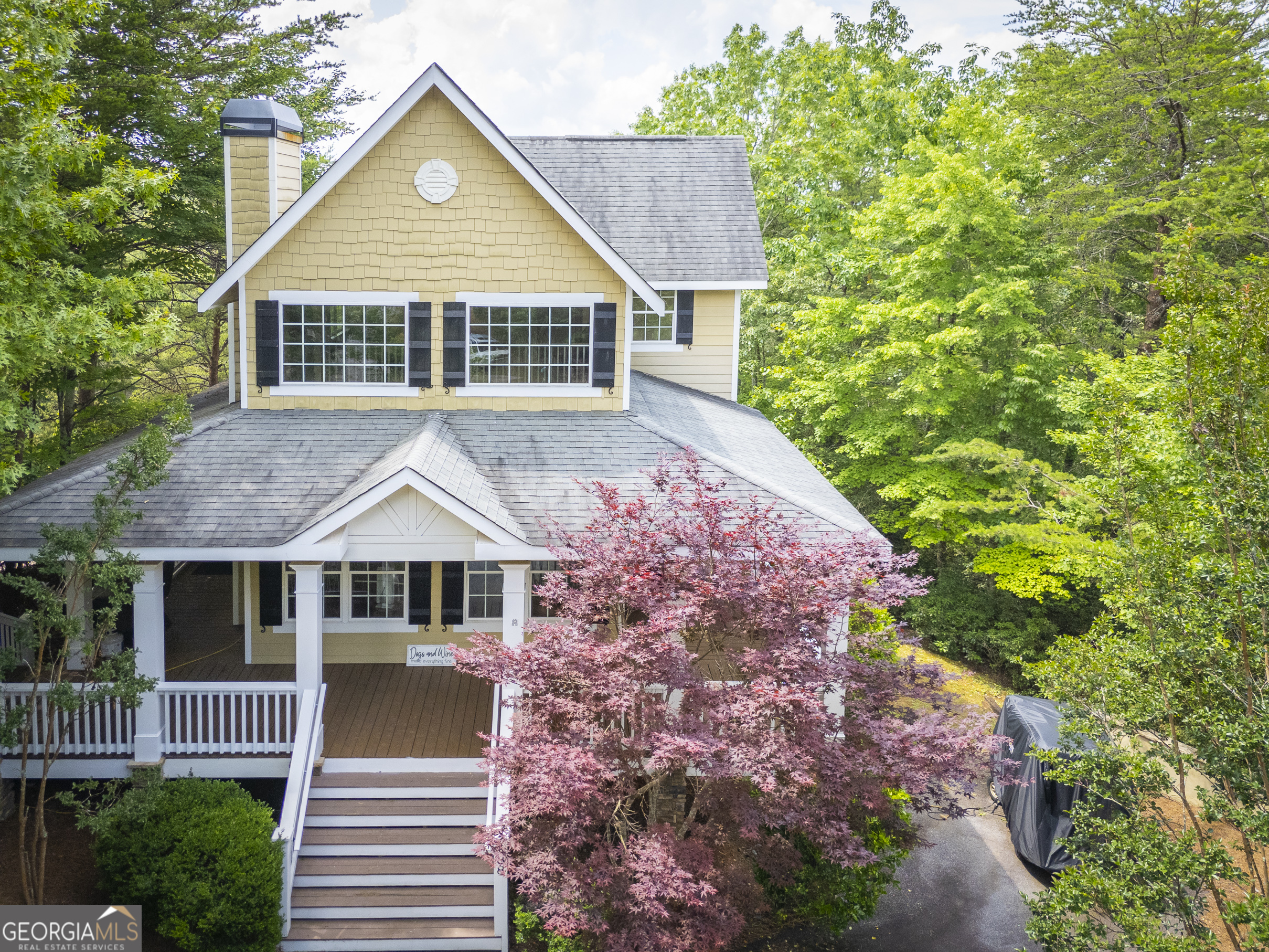 a front view of a house with a garden