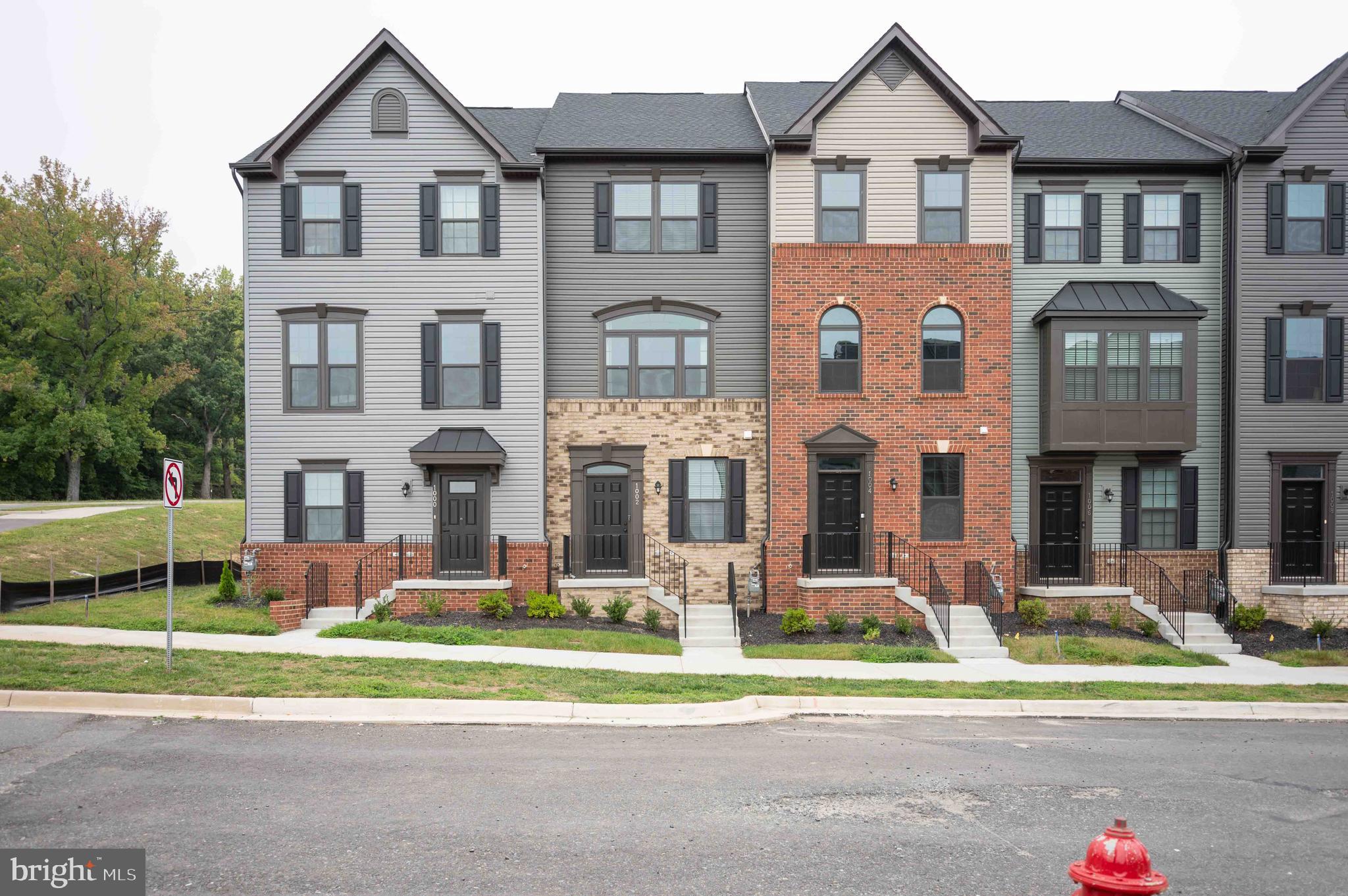 a front view of a residential apartment building with garage and traffic signal