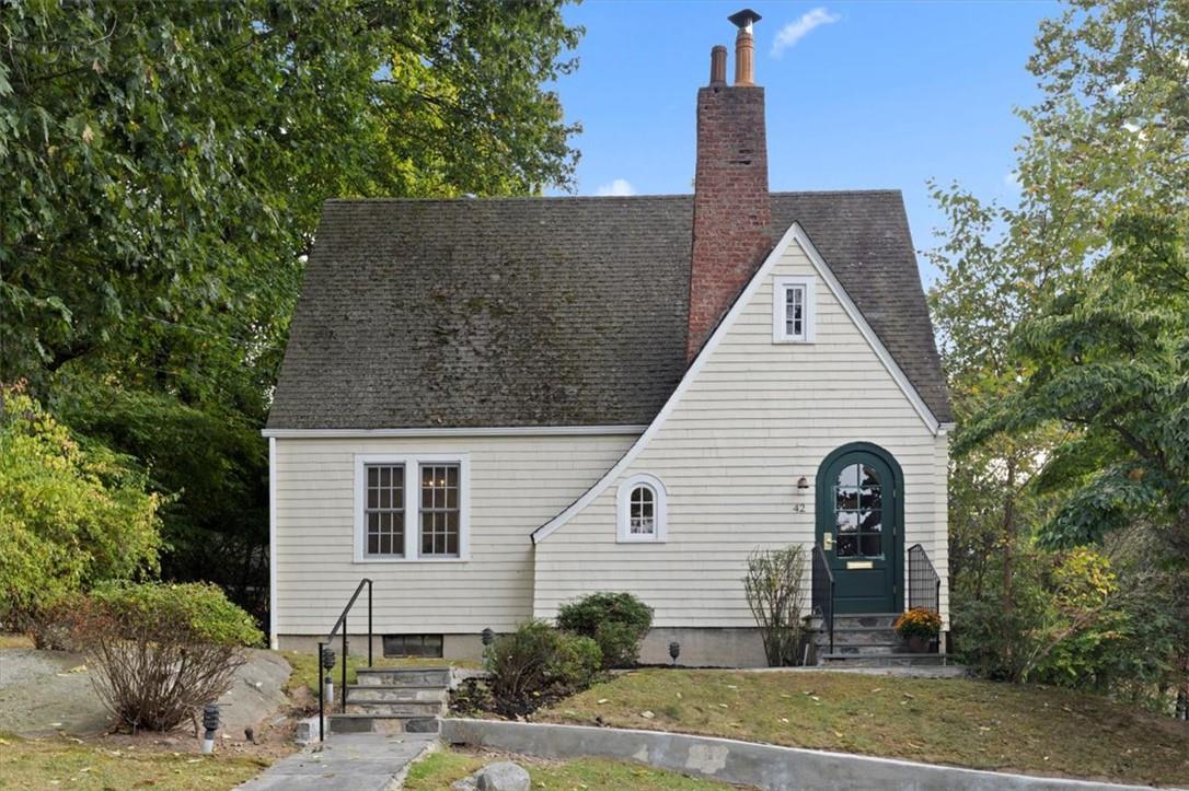 a front view of a house with garden