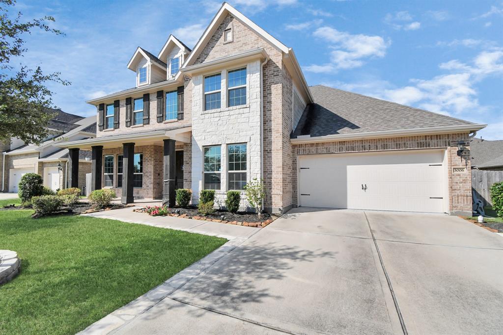 a front view of a house with a yard and outdoor seating