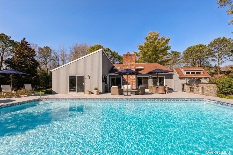 a view of a house with pool and a yard