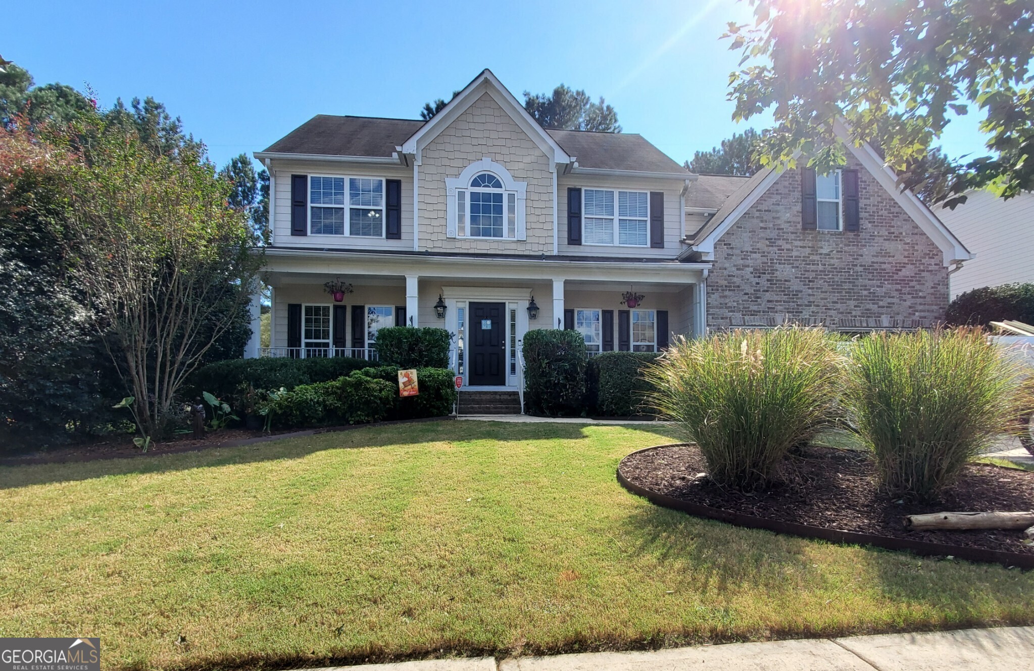 a front view of a house with garden