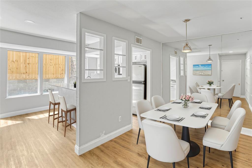 a dining room with furniture a chandelier and wooden floor