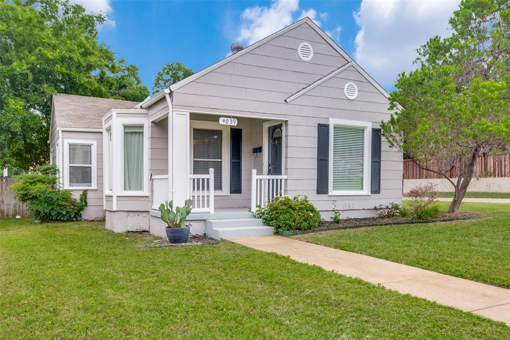 Bungalow featuring covered porch and a front yard