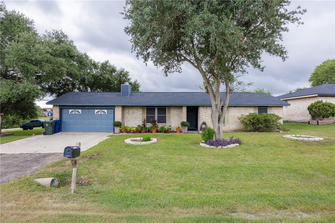 a front view of a house with a yard garage and outdoor seating