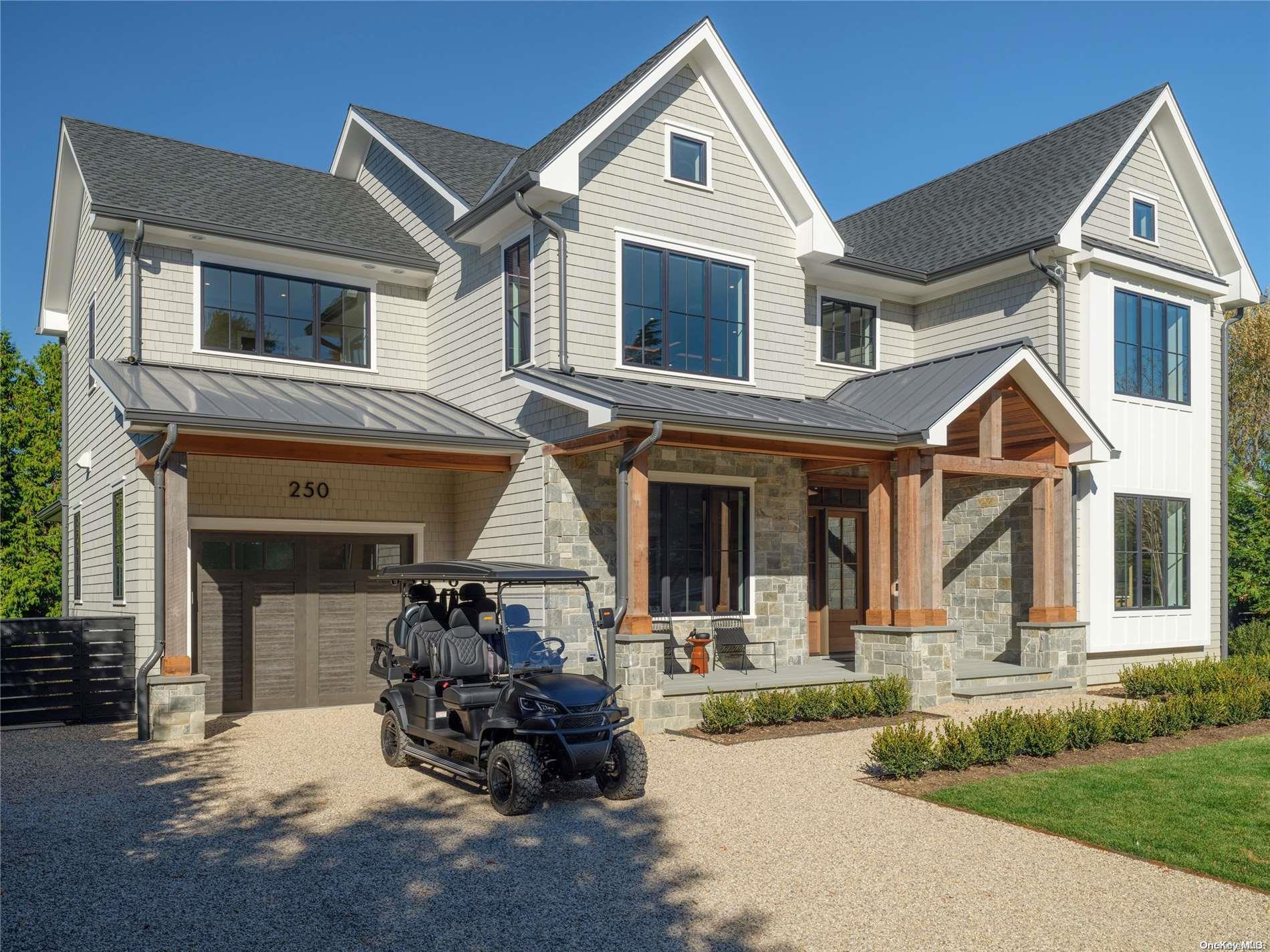 a front view of a house with a yard and outdoor seating