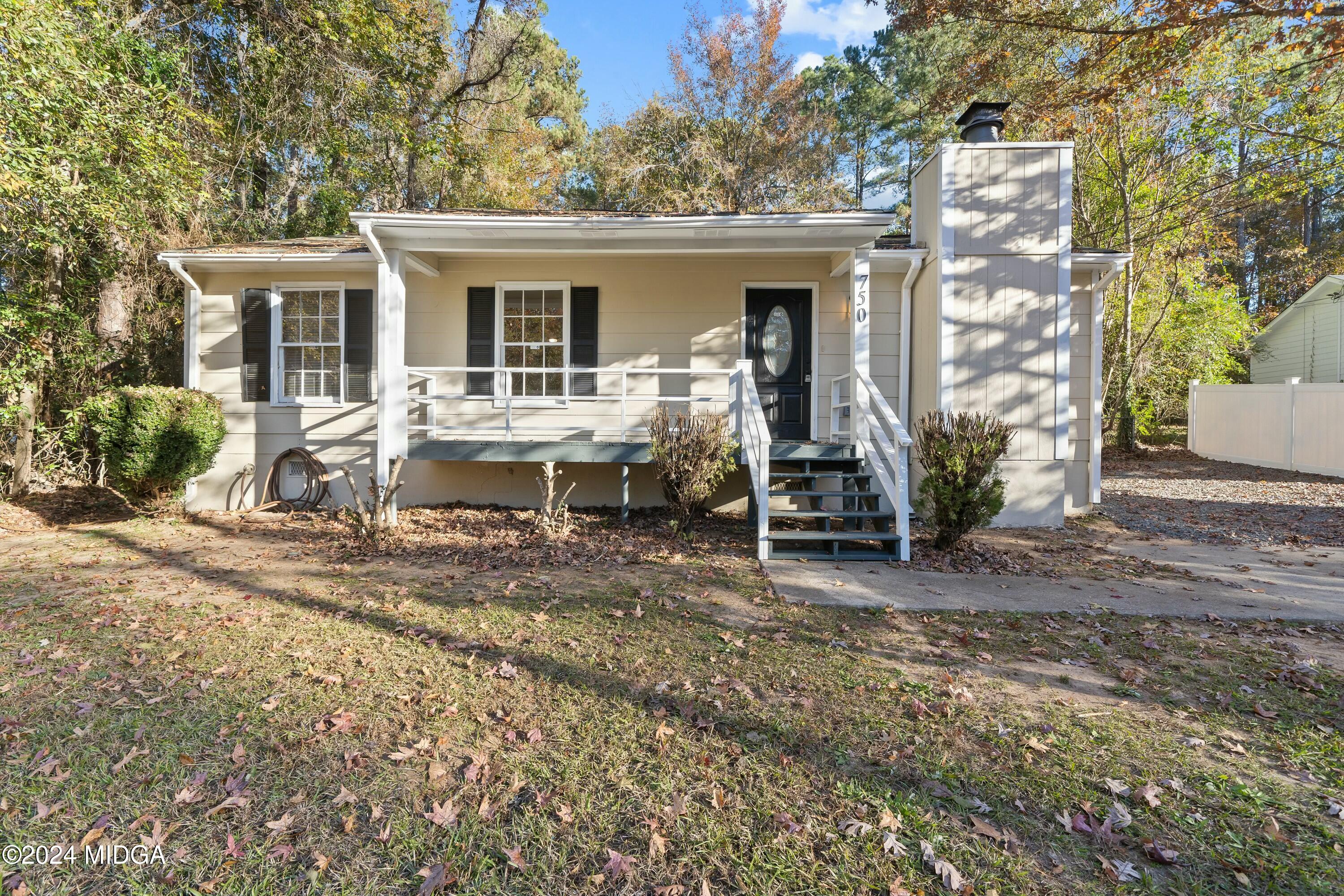 a view of a house with backyard porch and sitting area