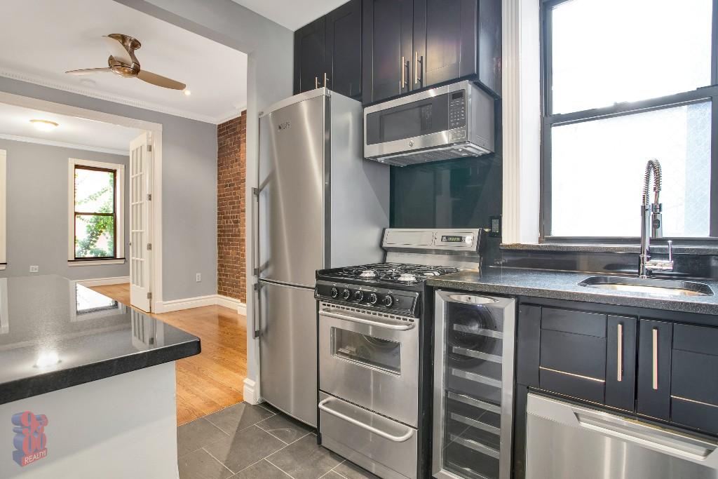 a kitchen with stainless steel appliances granite countertop a sink stove and refrigerator