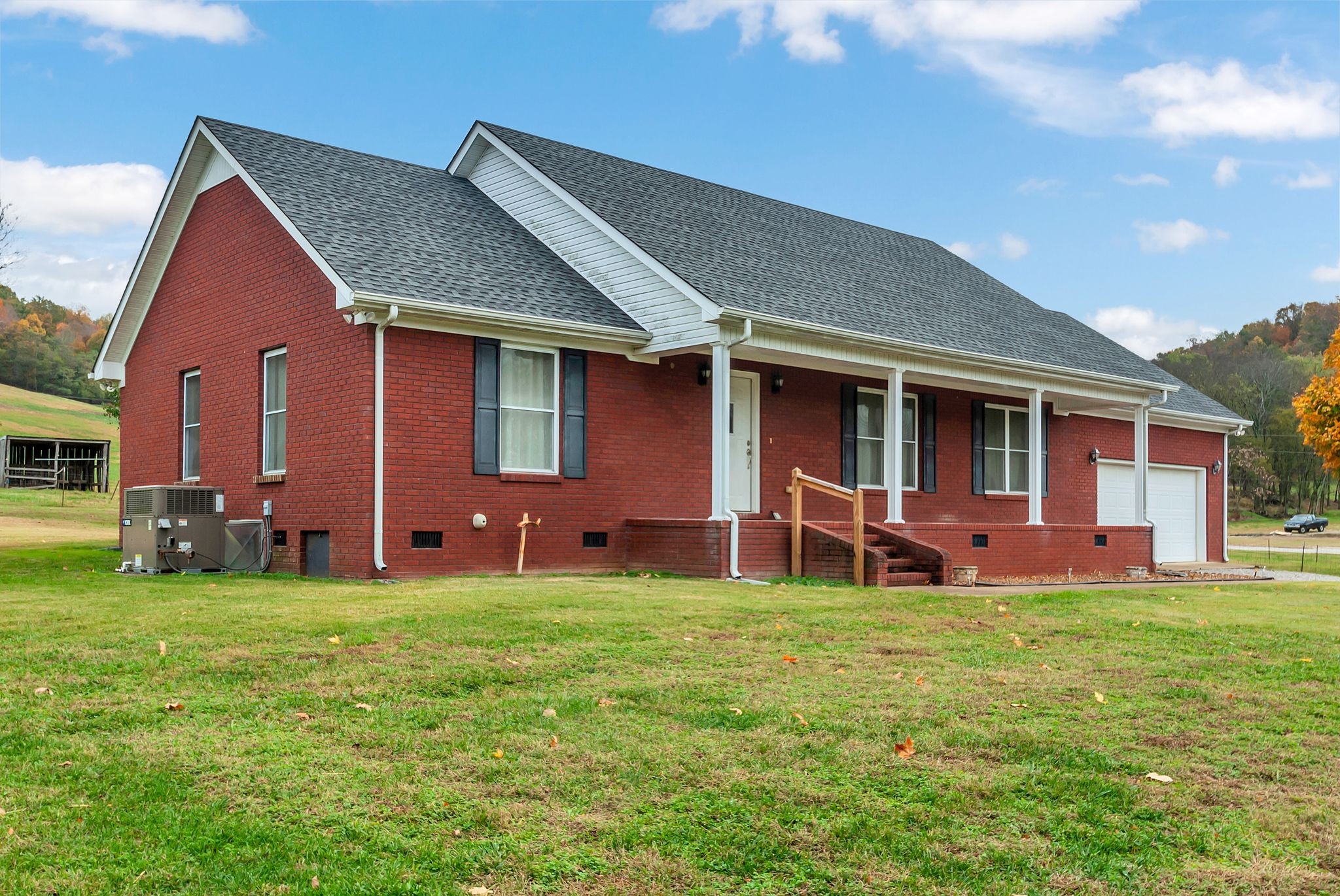 a view of a house with a yard and sitting area