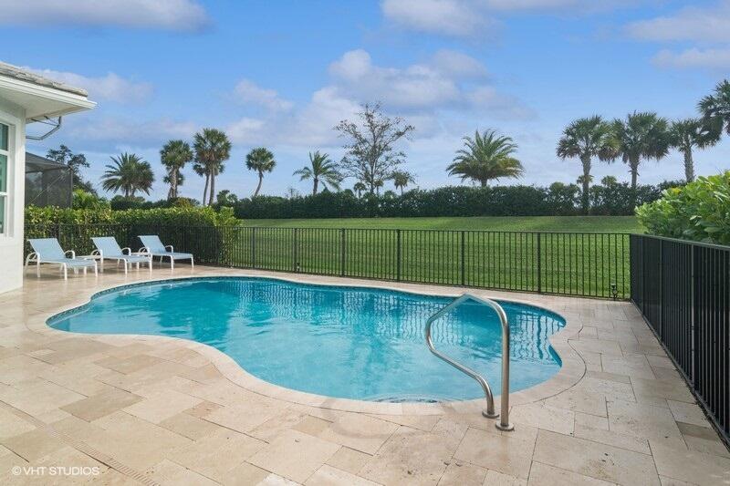 a view of a swimming pool and a yard